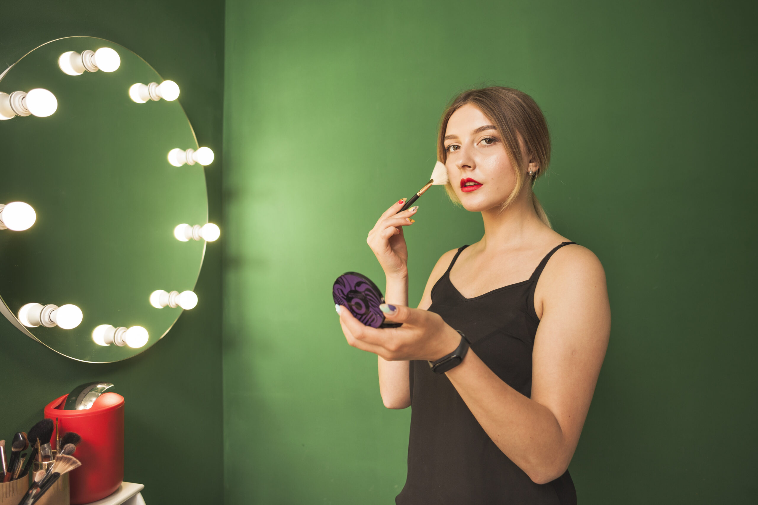 girl-doing-her-make-up-green-room celebrity hair and makeup artists